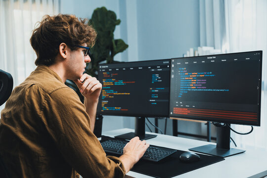 Working IT developer with stressful overworked in creating online software development coding on pc screen, thinking program for latest version application on website project at modern office. Gusher.