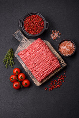 Fresh raw ground beef with salt, spices and herbs