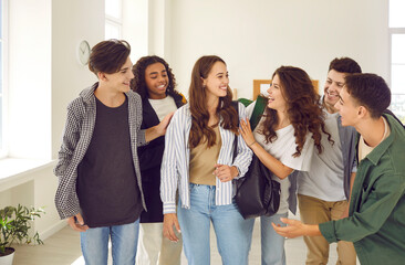 New student gets a warm welcome at the new school. Group of friendly high school pupils gather...