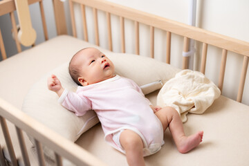 Newborn baby lying on the baby crib