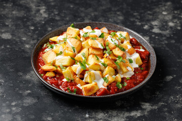 Patatas bravas, spanish deep fried potatoes with spicy sauce and garlic aioli