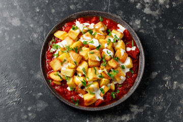 Patatas bravas, spanish deep fried potatoes with spicy sauce and garlic aioli