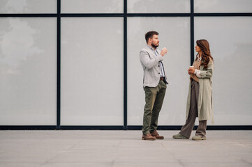 Business people having informal meeting while drinking coffee outdoors
