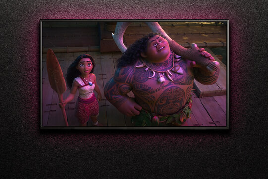 Moana 2 trailer or movie on TV screen. TV on black textured wall. Astana, Kazakhstan - September 17, 2024.