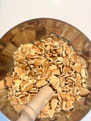 Crushed biscuits in a bowl. Preparation of a sweet salami.
