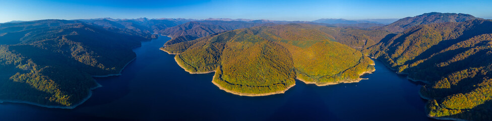 Panoramic aerial view of Vidraru lake in Arges county - Romania. Panorama with the Vidraru Reservoir seen from above in autumn