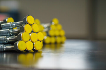 A bundle of new high-pressure hydraulic hoses are lying on a metal table. Hydraulic hoses with...