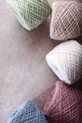 Multicolored balls of yarn for knitting. Handmade work. A set of colored cotton yarn. The concept of a hobby. Skeins of yarn for knitting as a background. Top view. Copy space.