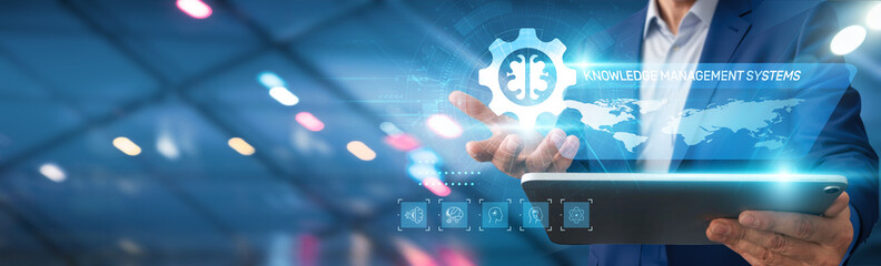 Businessman using tablet analyzing knowledge management systems, data trends, operational...