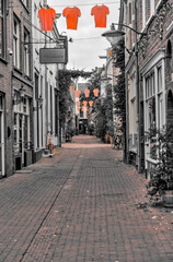 Arnhem, Netherlands - August 1, 2024: An old town street in Arnhem with an emphasis on the color orange, Netherlands
