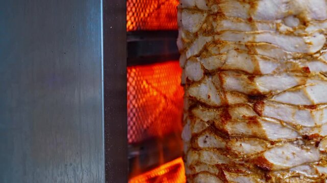 Juicy meat is fried on a shawarma spit.