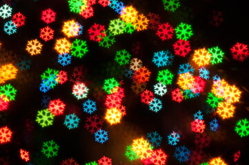 Christmas festive background. Blurred Christmas background, festive Christmas lights. Holiday Christmas glowing color lights with sparkles