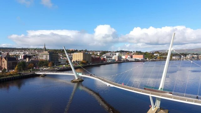 Peace Bridge over River Foyle in the City of Derry aka Londonderry in Northern Ireland aerial view by drone