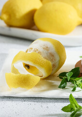 Peeled lemon on white table