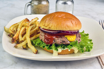 hamburger  top with  sliced onions on a brioche bun