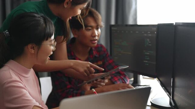 Slow motion back end software developer engineer for computer programming working together on debugging writing computing code, solving complex algorithms display on monitor in office. Burgeoning