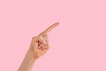 A hand gestures upward against a vibrant pink background, expressing curiosity and invitation to...