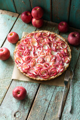 Open apple pie with apples rolled in the shape of rosebuds