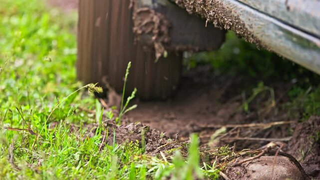 car tire slipping while stuck in a dirt, heating up and steaming in attempt to get free, closeup with selective focus