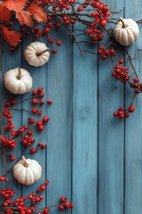 Colorful autumn pumpkins and berries arranged on a blue wooden background for seasonal decor