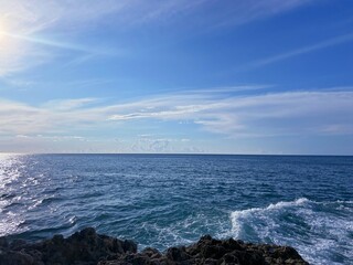 Blue sea waves, rocky coast and sky 