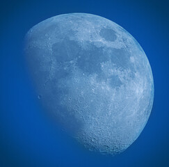 A stunning moon against a clear blue sky, creating a breathtaking celestial scene