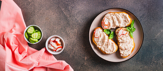 Delicious sandwiches with crab meat and cucumber pate on a plate top view web banner