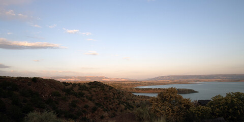 Panoramic view of dawn’s first pink light at Abiquiu Lake, an Army Corps of Engineers reservoir in northern New Mexico