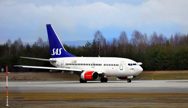 Scandinavian Airlines SAS plane landing on the runway in Oslo Gardermoen Airport