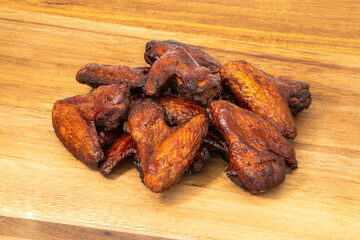 Delicious and Crispy Chicken Wings Deliciously Piled on a Wooden Surface Ready to Eat