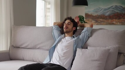 Happy relaxed young man rest lounge lean on couch enjoy peaceful mood, healthy lazy calm guy dreaming breathing fresh air sit on comfortable sofa in living room on stress free cozy day at home
 - Powered by Adobe