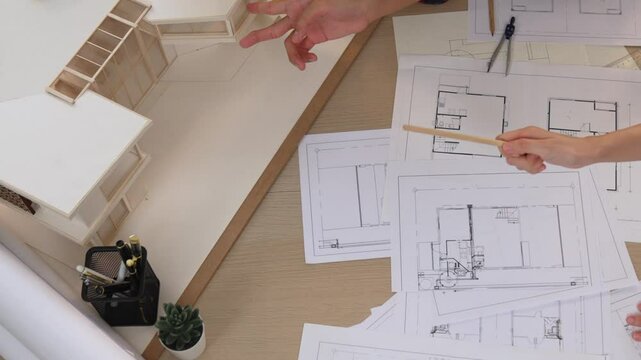Slow motion interior designer drafting blueprint with customer supervise and oversee interior designer draw house room layout on home based on client demand. Architectural customer service. Burgeoning