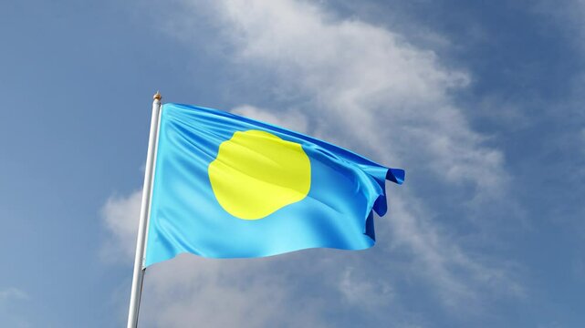 Flag of Palau on a blue sky, flag on a flag pole waving in the wind, oceania country, national symbol of Palau, video of a flag