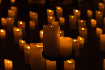 blurred symphonic orchestra on stage with lots of candles