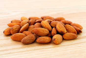 Tasty almonds on wooden table