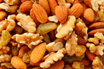 Covered background a mix of raisins, nuts and almonds