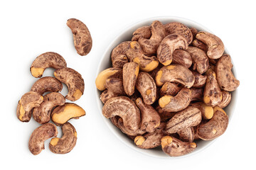 cashew nut with shell in ceramic bowl isolated on white background. Top view. Flat lay