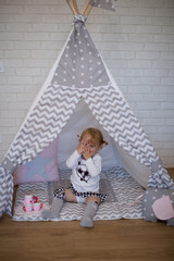 Adorable beautiful happy smiling ginger-haired toddler girl is playing peekaboo  © Tina