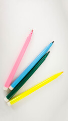 Colorful markers arranged on a white background