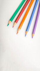 Colorful pencils arranged on white background 