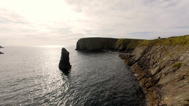 FPV Flight over the west coast of Ireland in Donegal at Malin Beg - A picturesque and beautifully scenic coastline showcases tranquil azure waters alongside lush, green hills