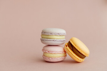 stack of delicious almond macaroons on plain background, delicate dessert