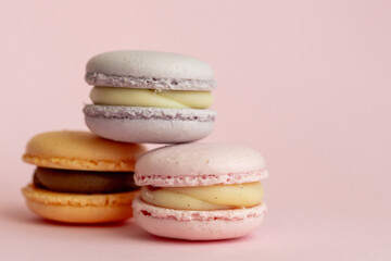 stack of delicious almond macaroons on plain background, delicate dessert