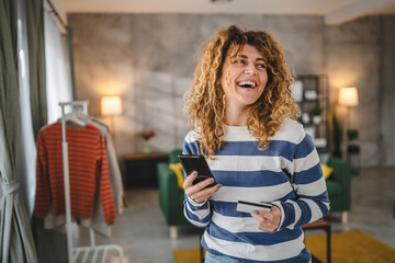 young woman caucasian female hold credit card online shopping at home