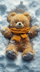Teddy bear wearing an orange scarf is lying on its back in the snow, looking cozy and playful