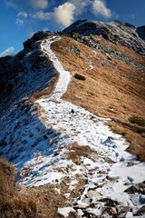 a snowy high mountain trail to the top