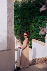 Young woman walking in Old town of Nerja in Spain. Beautiful architecture of the Spanish town in...
