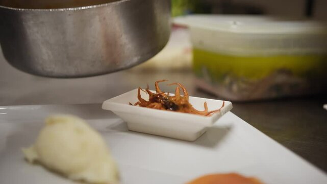 Plating Of A Raw And Cooked Fish Based Appetizer In A Luxury Italian Kitchen