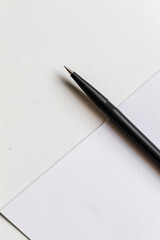 Black pen on blank paper in minimal space