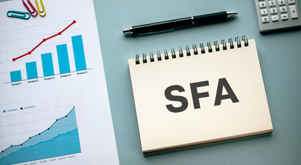 There is notebook with the word SFA. It is an abbreviation for Sales Force Automation as...